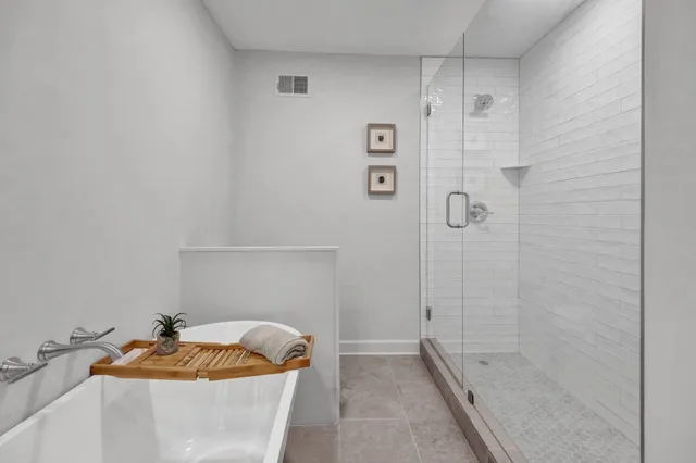 a bath tub sitting next to a white sink