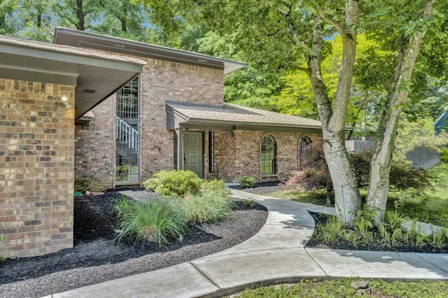 a front view of a house with garden