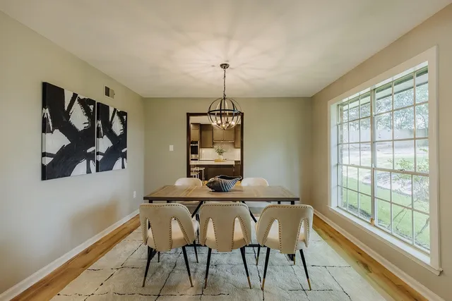 a dining room with furniture and window