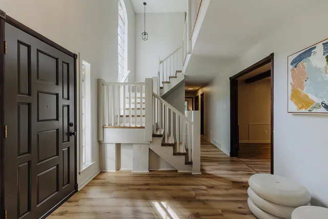 a view of entryway and hall with wooden floor