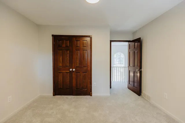 an empty room with closet area