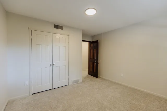 an empty room with closet area