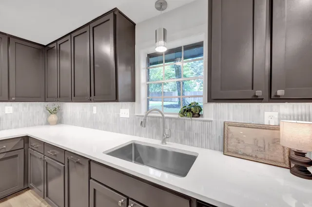a kitchen with a sink and a refrigerator
