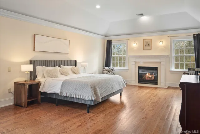 a spacious bedroom with a bed and a fireplace