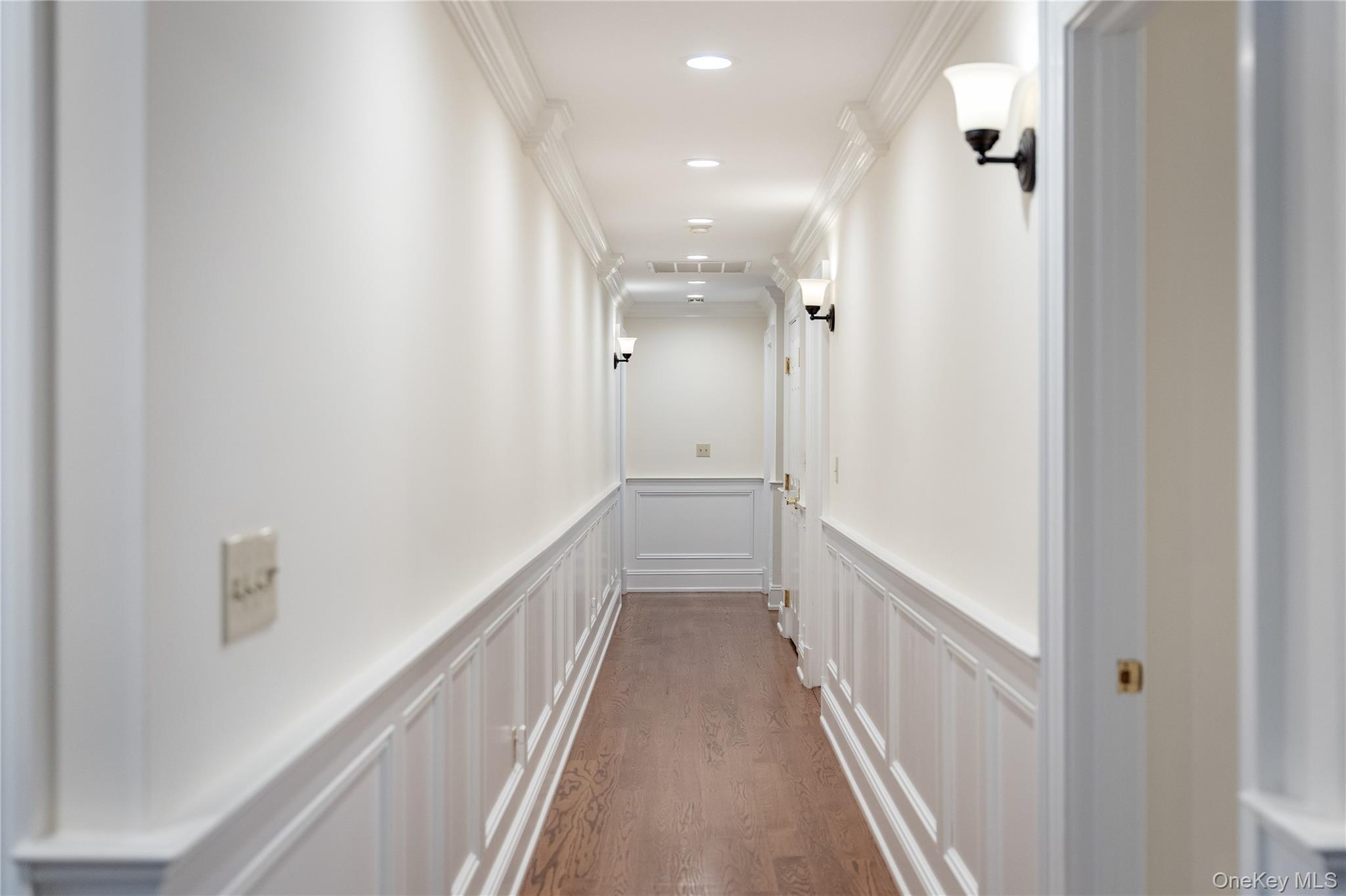 11 Lost Nations Road Pound Ridge, NY 10576 - Photo 32 of 42 a view of a hallway with wooden floor and staircase