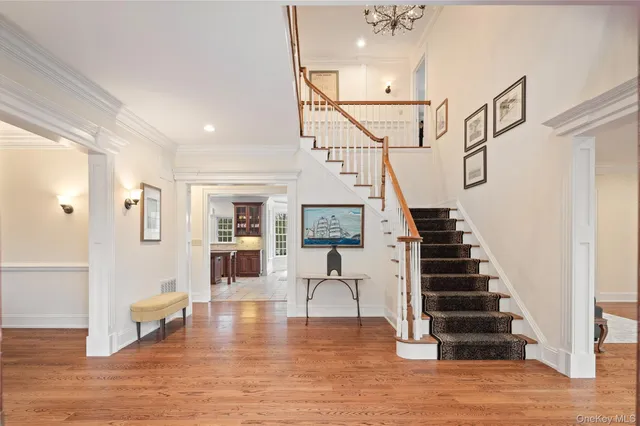 a view of entryway and hall with wooden floor