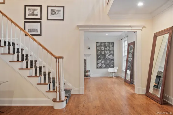 a view of entryway with wooden floor and stairs