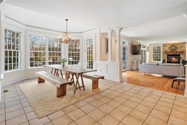 a living room with furniture a flat screen tv and a large window