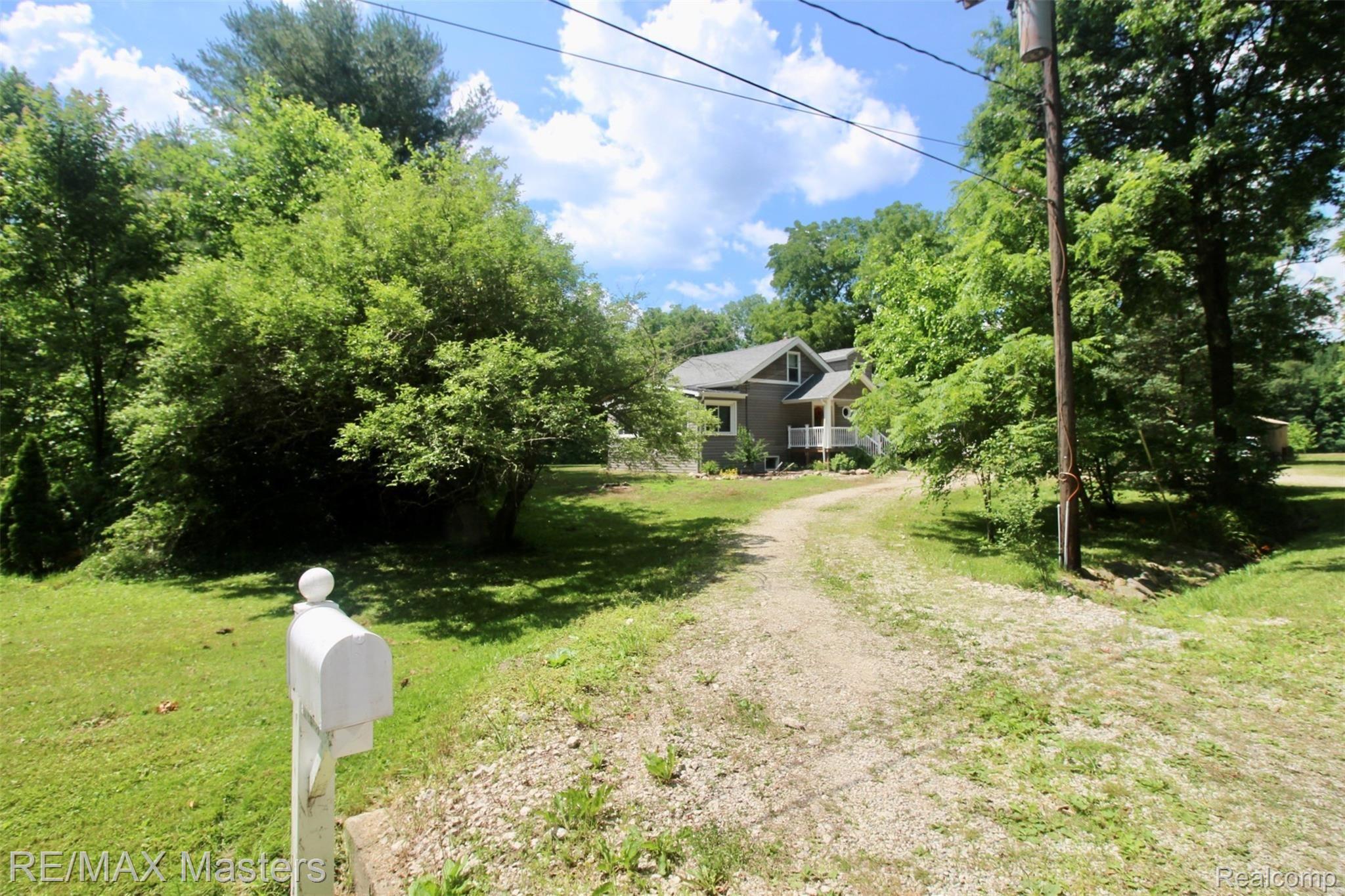 32430 King Road New Boston, MI 48164 - Photo 3 of 36 A long long driveway leads back to our private and peaceful setting, one of the beautiful elements of this 7+acre parcel.