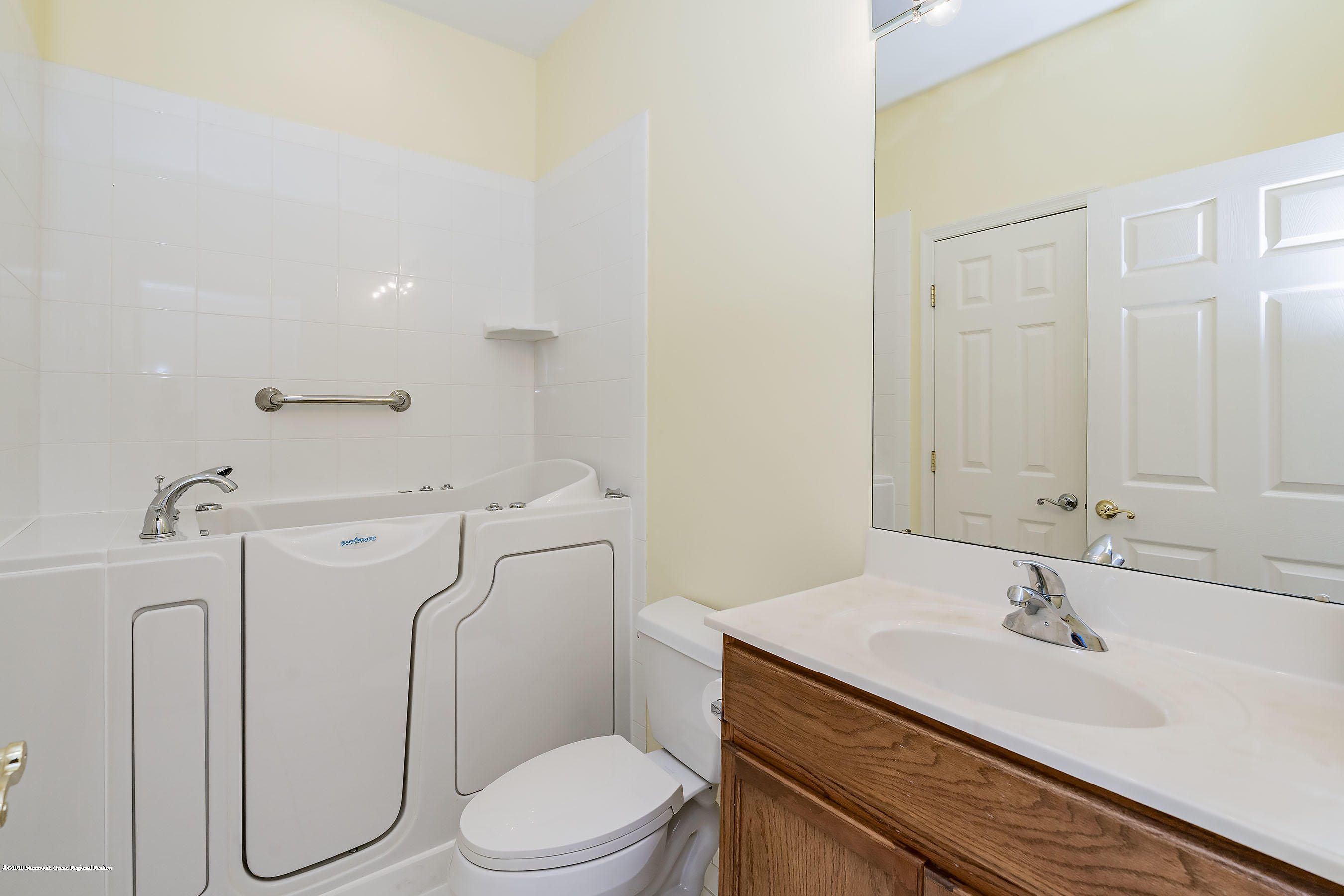 7 Elsworth Place Holmdel, NJ 07733 - Photo 17 of 23 a bathroom with a granite countertop sink a toilet and a mirror