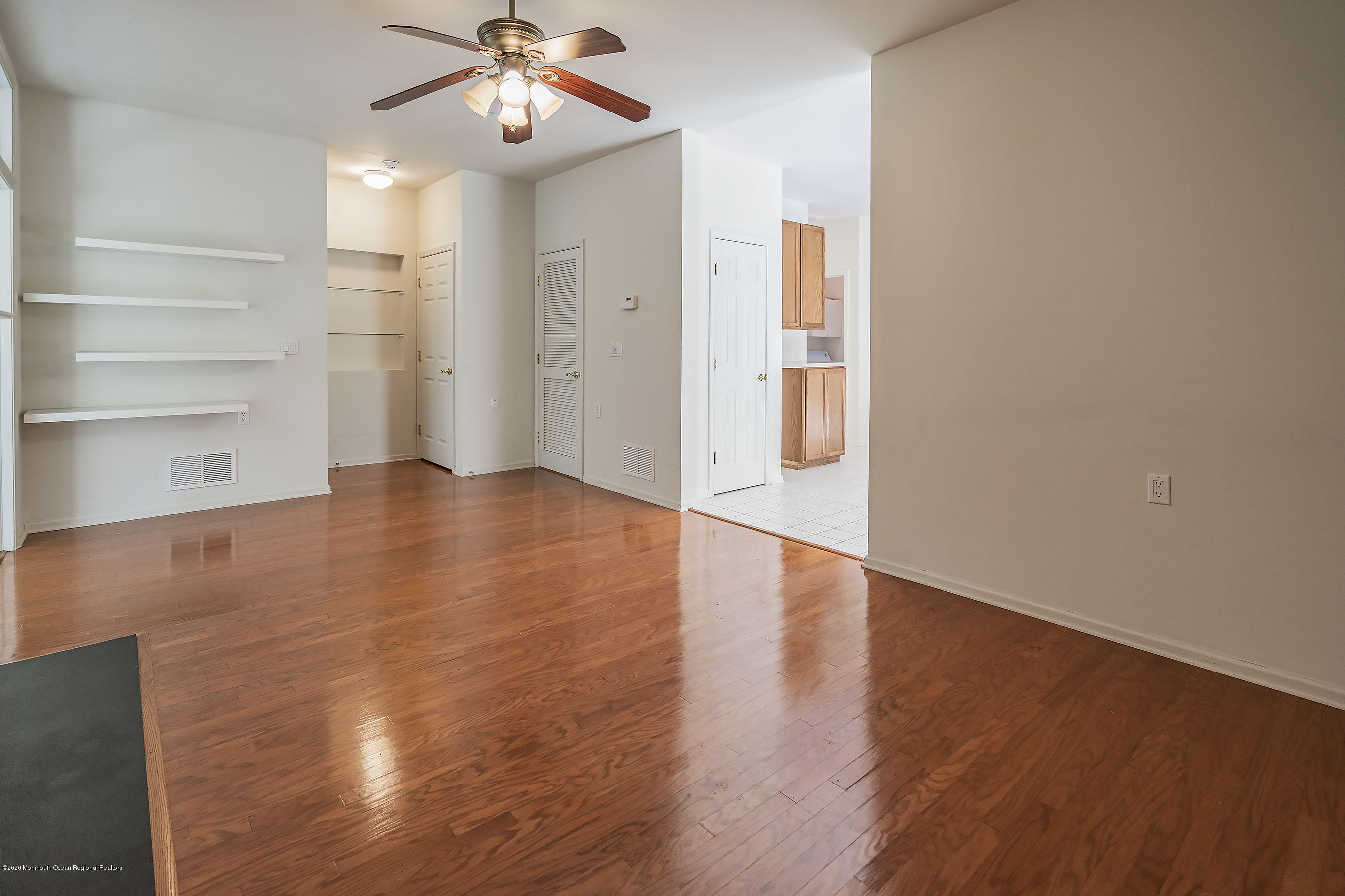 7 Elsworth Place Holmdel, NJ 07733 - Photo 8 of 23 a view of an empty room with a window and wooden floor