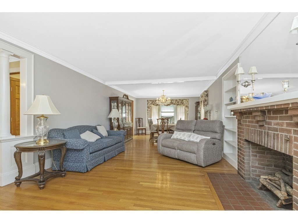 230 Clark Road Brookline, MA 02445 - Photo 8 of 27 a living room with furniture and a fireplace