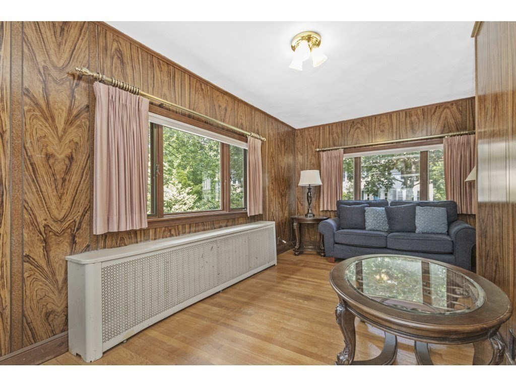 230 Clark Road Brookline, MA 02445 - Photo 9 of 27 a living room with furniture and a large window