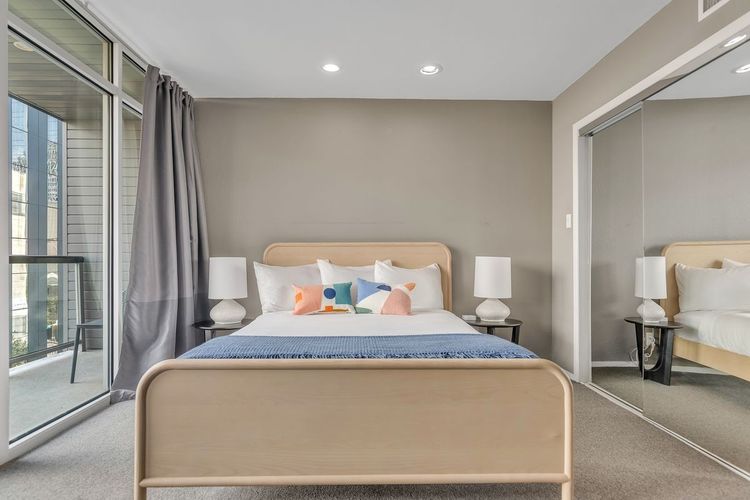 119 East 6th Street, Unit 701 Austin, TX 78701 - Photo 12 of 20 a bedroom with a bed and chair