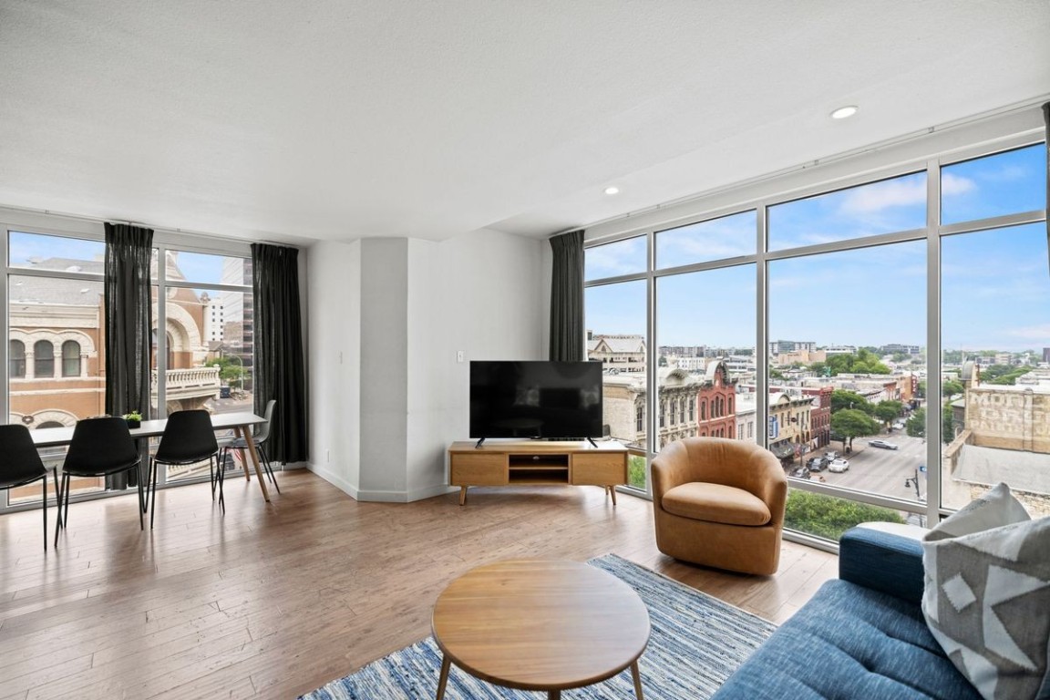 119 East 6th Street, Unit 701 Austin, TX 78701 - Photo 2 of 20 a living room with furniture and a flat screen tv