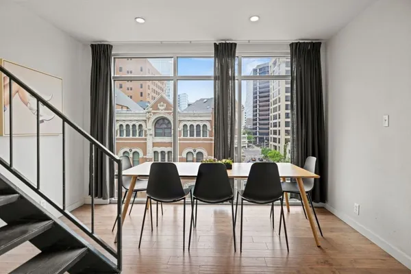 a view of a dining room with furniture and wooden floor