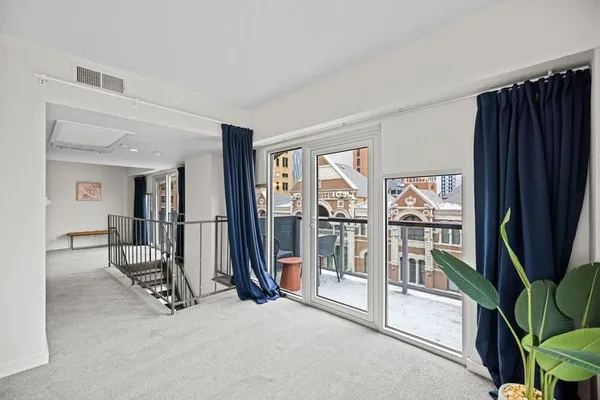 a view of a livingroom with a furniture and floor to ceiling window