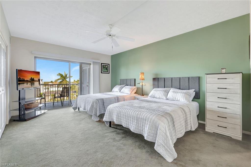 60 West Pelican Street, Unit 401 Naples, FL 34113 - Photo 19 of 31 a spacious bedroom with a bed and a walk in closet