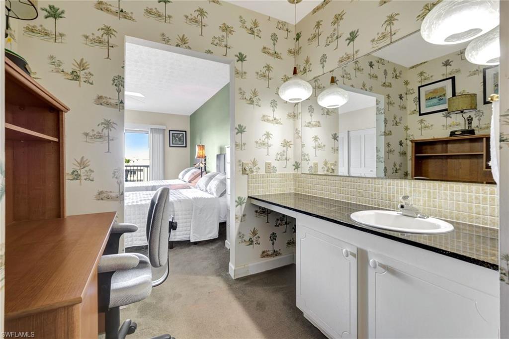 60 West Pelican Street, Unit 401 Naples, FL 34113 - Photo 21 of 31 a bathroom with a sink vanity and a mirror