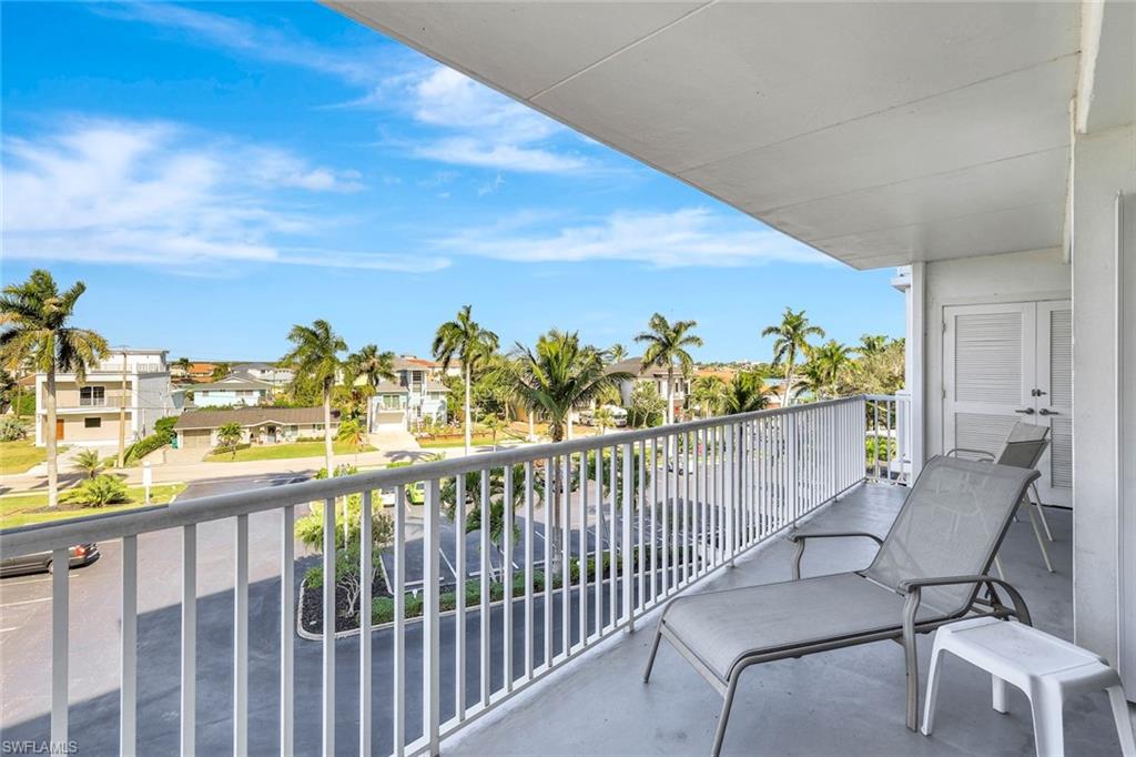 60 West Pelican Street, Unit 401 Naples, FL 34113 - Photo 24 of 31 a view of a balcony with chairs
