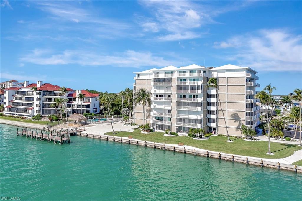 60 West Pelican Street, Unit 401 Naples, FL 34113 - Photo 30 of 31 a view of large building with outdoor space