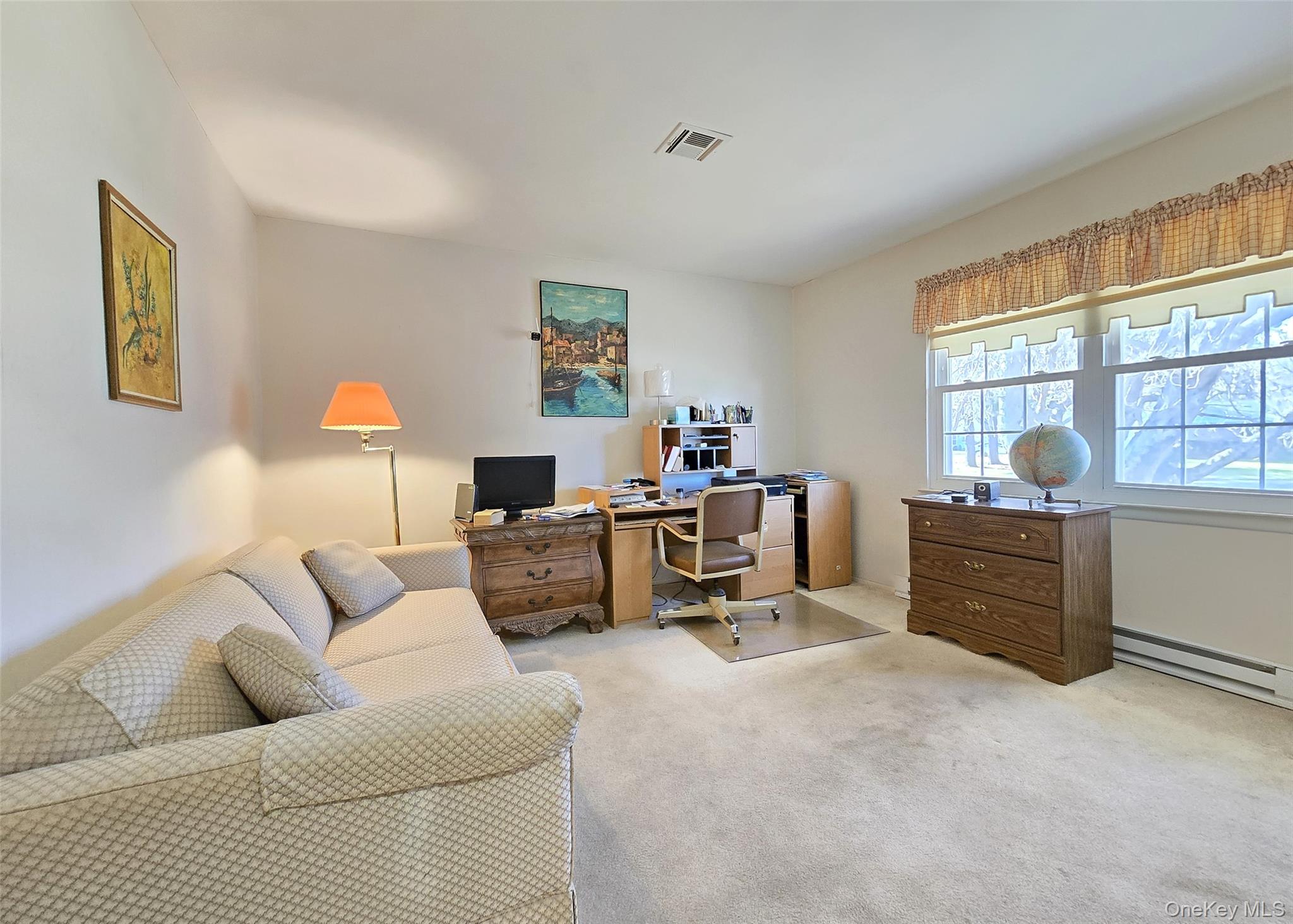 289 Cardiff Court, Unit B Ridge, NY 11961 - Photo 16 of 20 a living room with furniture a couch and a window