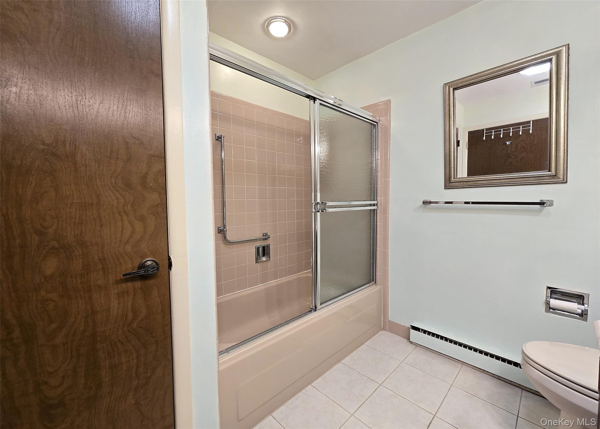 289 Cardiff Court, Unit B Ridge, NY 11961 - Photo 17 of 20 a bathroom with a granite countertop sink mirror and toilet