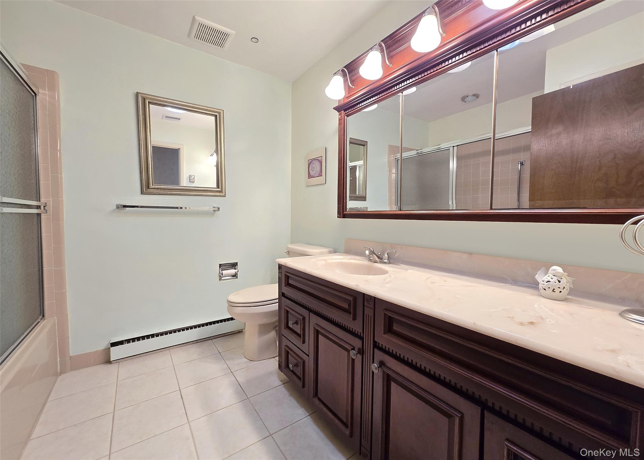 289 Cardiff Court, Unit B Ridge, NY 11961 - Photo 18 of 20 a bathroom with a sink and a mirror