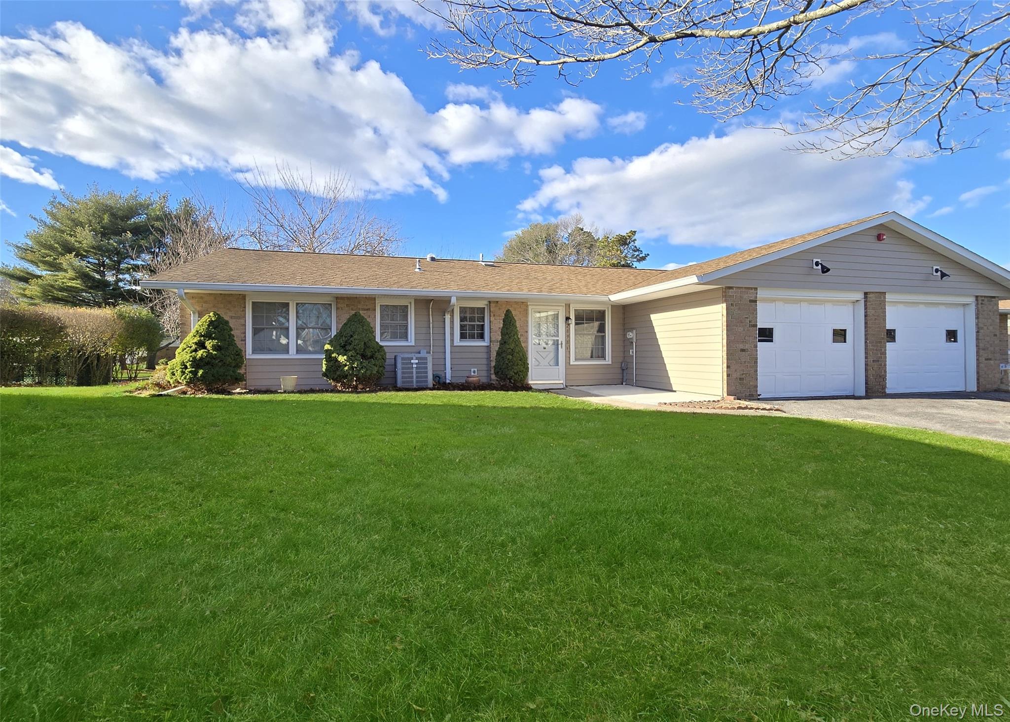 289 Cardiff Court, Unit B Ridge, NY 11961 - Photo 20 of 20 a front view of house with yard and green space
