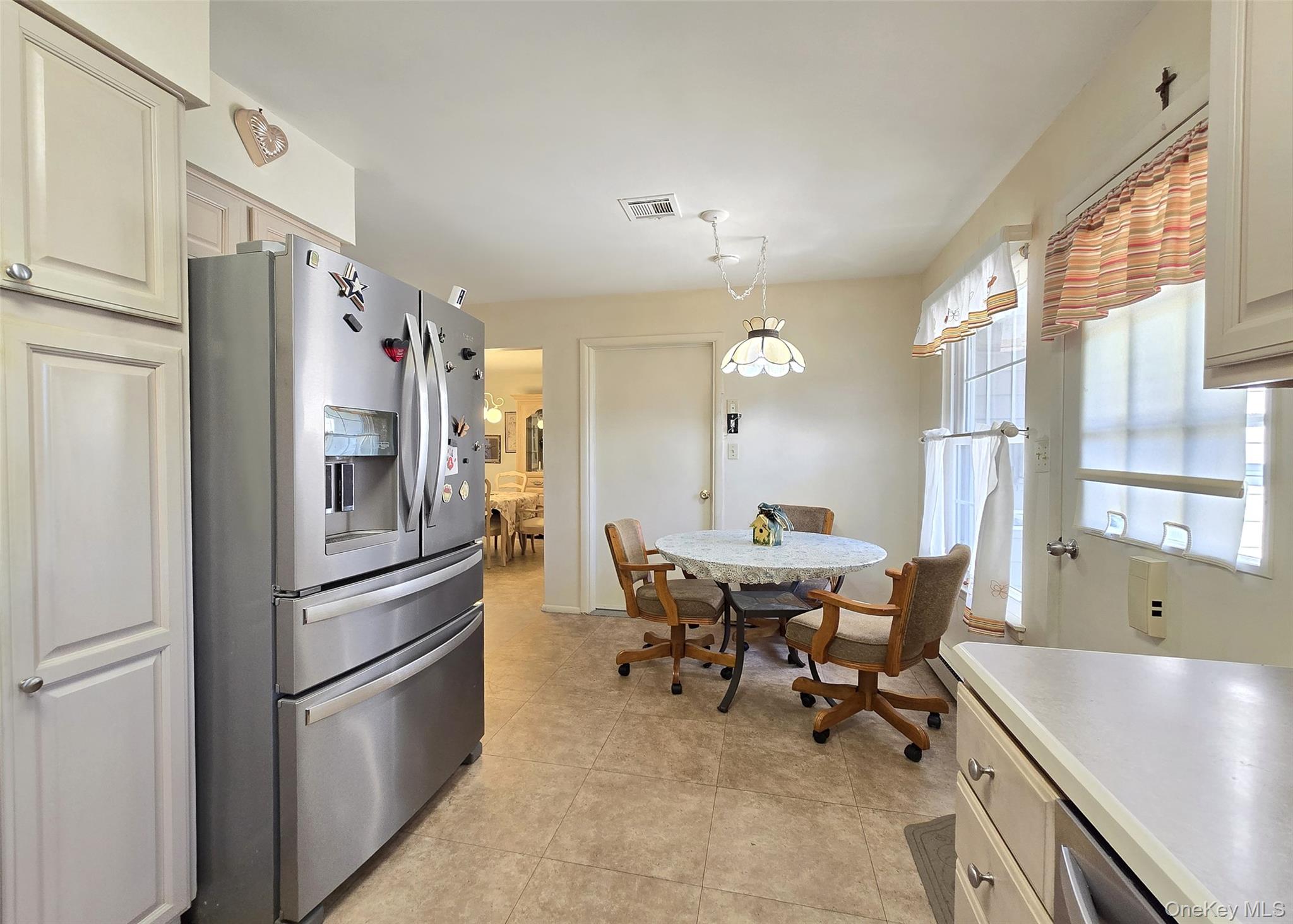 289 Cardiff Court, Unit B Ridge, NY 11961 - Photo 8 of 20 a kitchen with stainless steel appliances granite countertop a refrigerator and a sink
