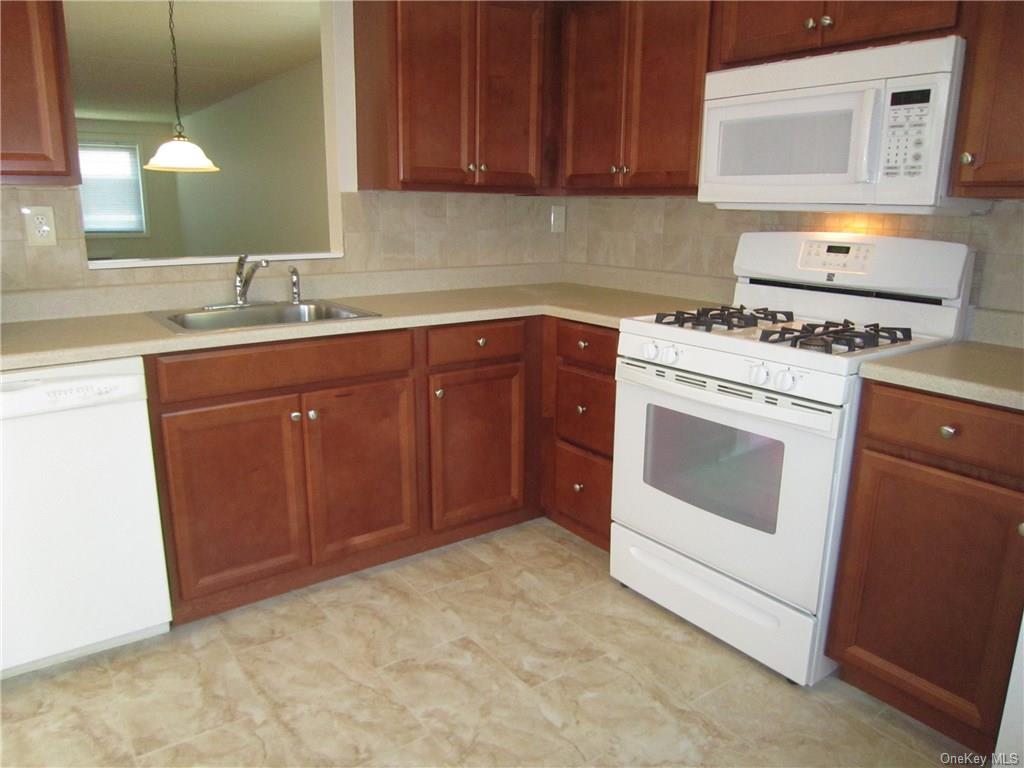 a kitchen with a stove sink and cabinets
