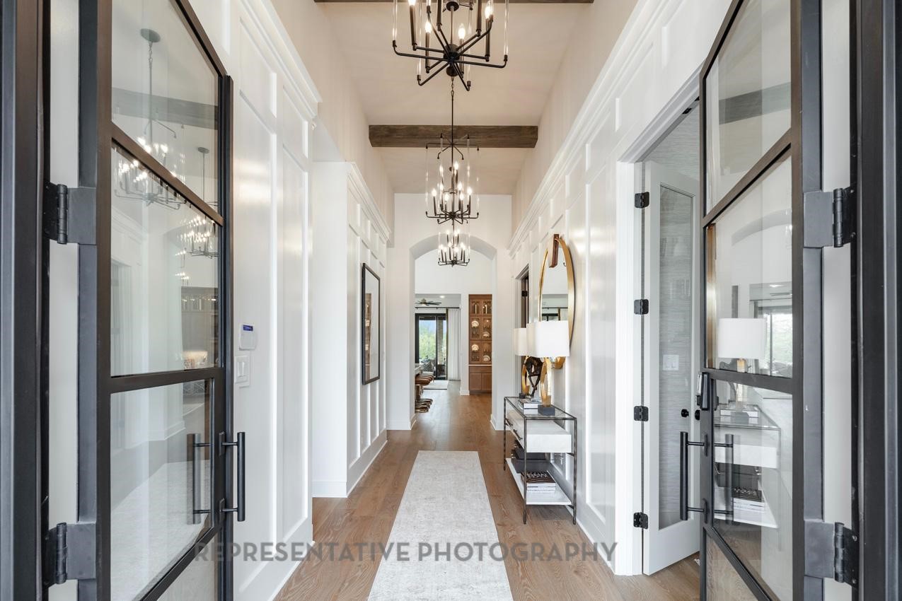 207 Wooded Rill Court Willis, TX 77318 - Photo 15 of 28 a view of a chandelier in a hallway with a chandelier
