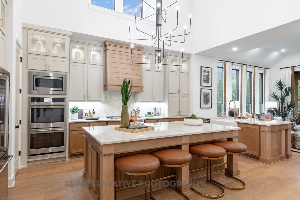 207 Wooded Rill Court Willis, TX 77318 - Photo 2 of 28 a kitchen with a stove a sink and chairs