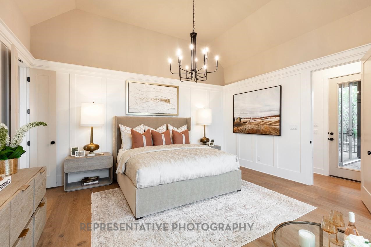 207 Wooded Rill Court Willis, TX 77318 - Photo 8 of 28 a spacious bedroom with a bed and a chandelier