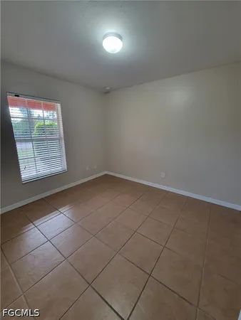 a view of an empty room and a window