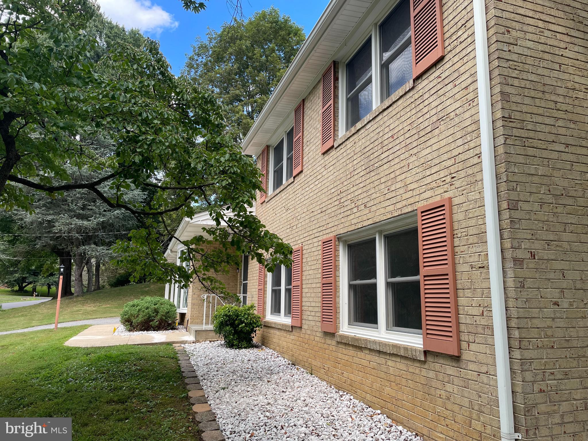 13409 Doncaster Lane Silver Spring, MD 20904 - Photo 1 of 37 a front view of a house with a yard and potted plants