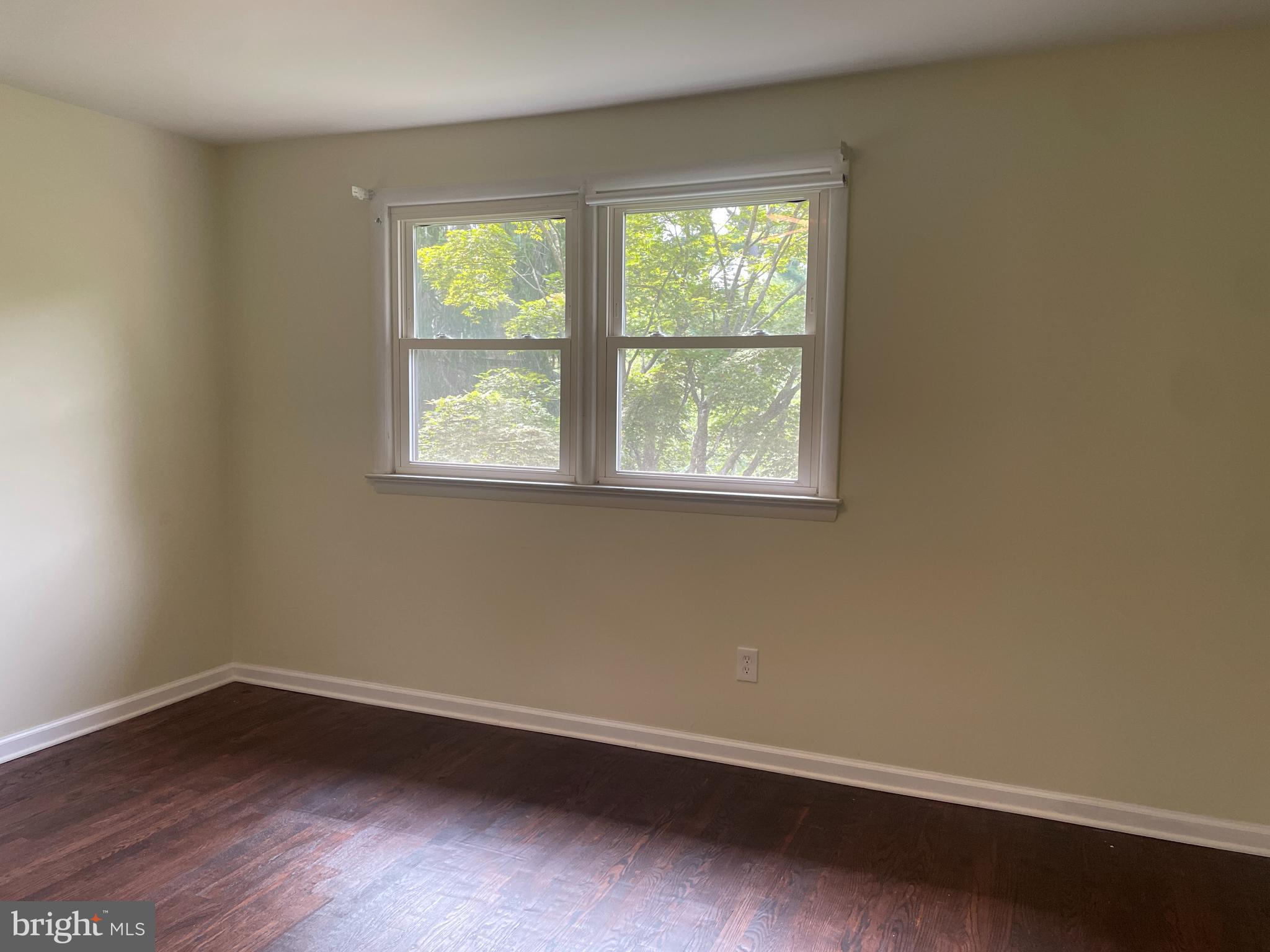 13409 Doncaster Lane Silver Spring, MD 20904 - Photo 19 of 37 an empty room with wooden floor and windows