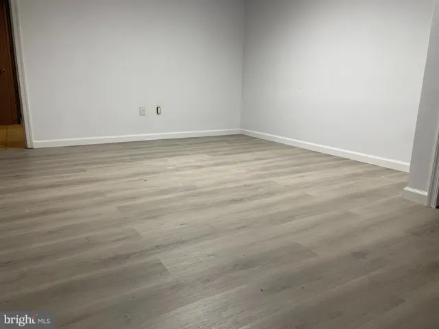 an empty room with wooden floor