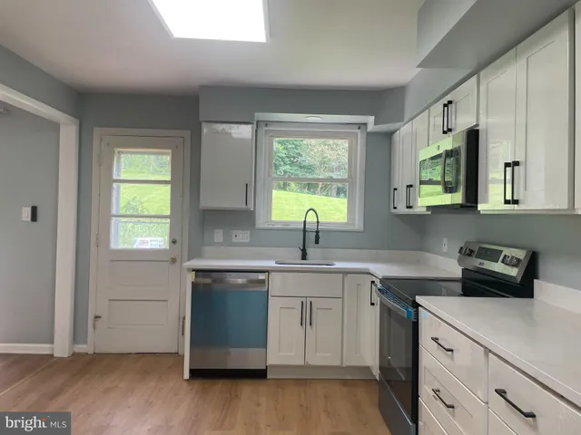 a kitchen with a sink stove and cabinets