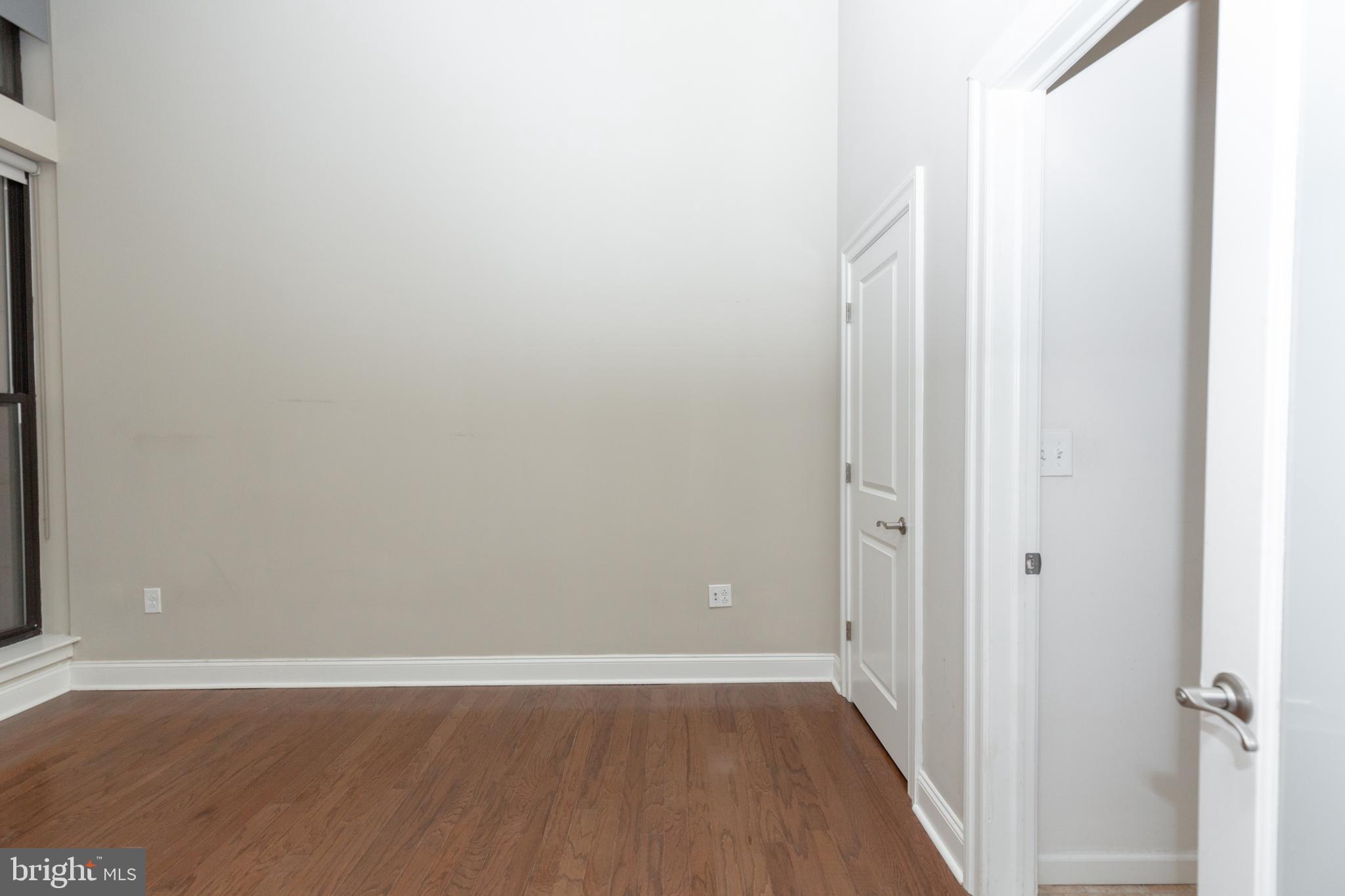 1411-2 Walnut Street, Unit 312 Philadelphia, PA 19102 - Photo 13 of 23 a view of a small space with wooden floor and a window