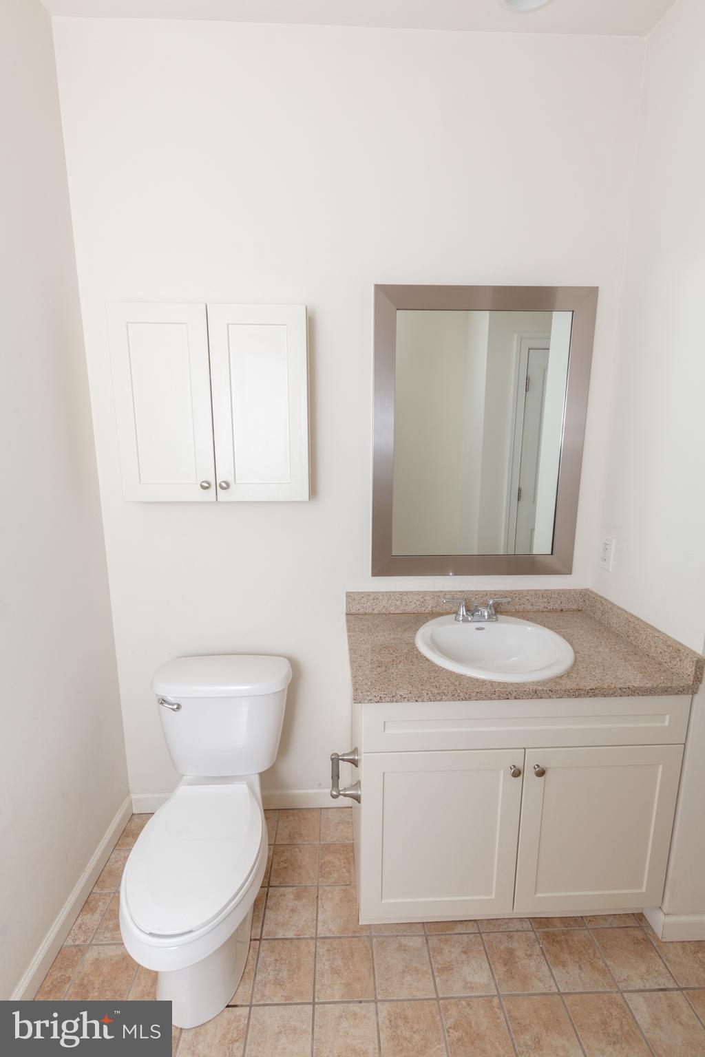 1411-2 Walnut Street, Unit 312 Philadelphia, PA 19102 - Photo 15 of 23 a bathroom with a toilet sink and mirror