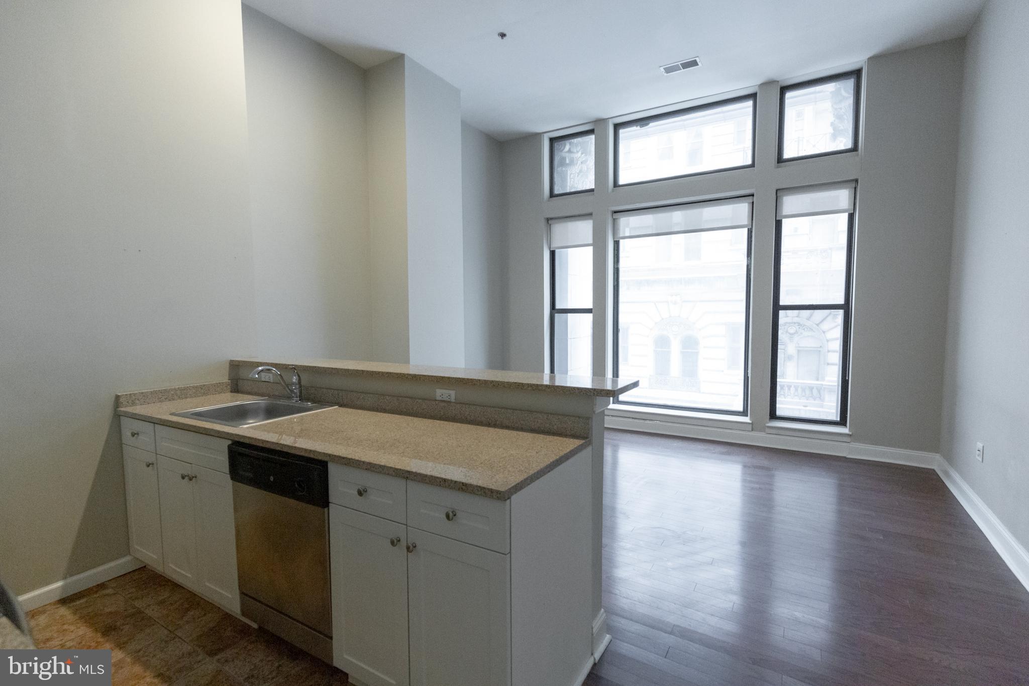 1411-2 Walnut Street, Unit 312 Philadelphia, PA 19102 - Photo 5 of 23 an empty room with wooden floor and windows