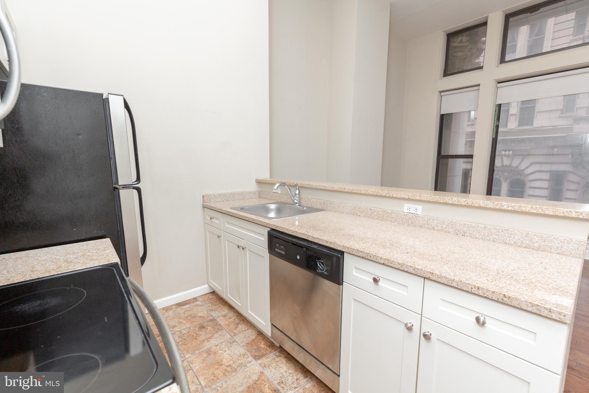 1411-2 Walnut Street, Unit 312 Philadelphia, PA 19102 - Photo 6 of 23 a bathroom with a sink a toilet and a mirror