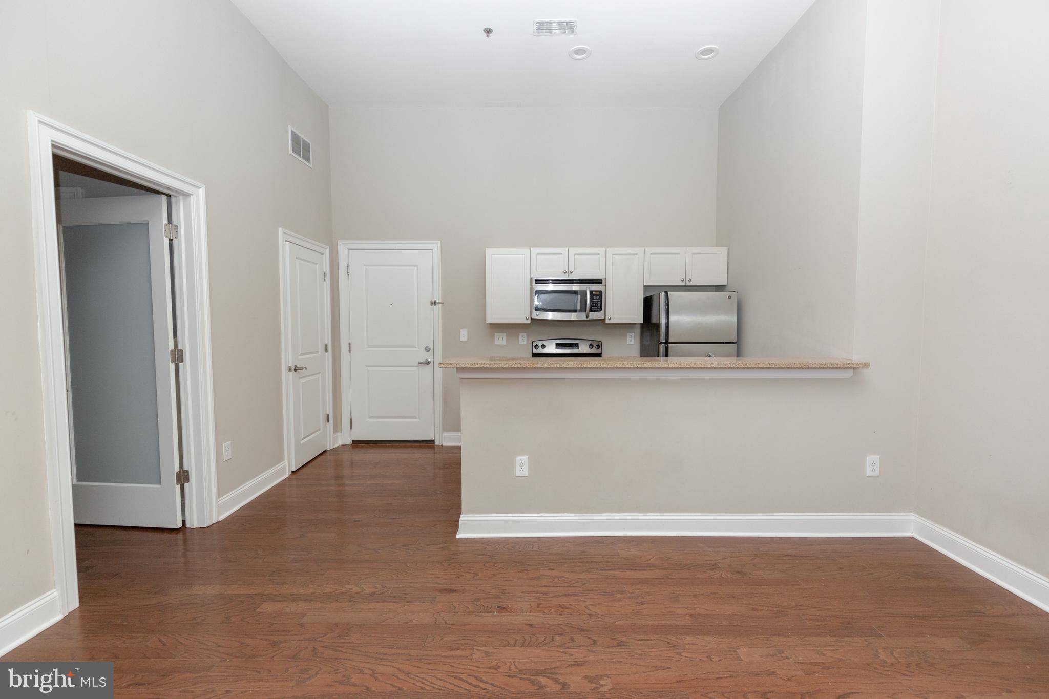 1411-2 Walnut Street, Unit 312 Philadelphia, PA 19102 - Photo 10 of 23 a view of a kitchen with refrigerator and microwave