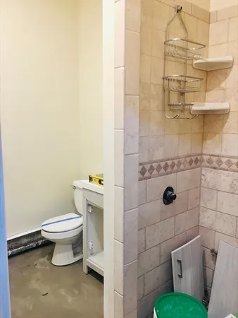 a white toilet sitting next to a bathroom sink