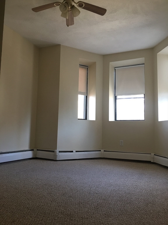96 Marcella Street, Unit 2 Boston, MA 02119 - Photo 17 of 37 an empty room with windows