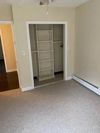 a view of an empty room with a closet