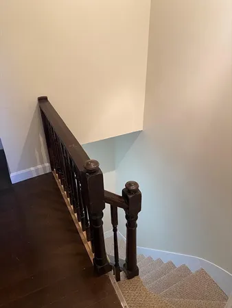 an empty room with wooden floor and a door