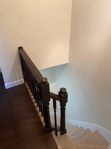 an empty room with wooden floor and a door