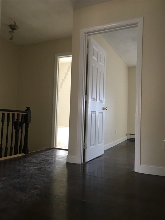 96 Marcella Street, Unit 2 Boston, MA 02119 - Photo 28 of 37 an empty room with wooden floor and a door